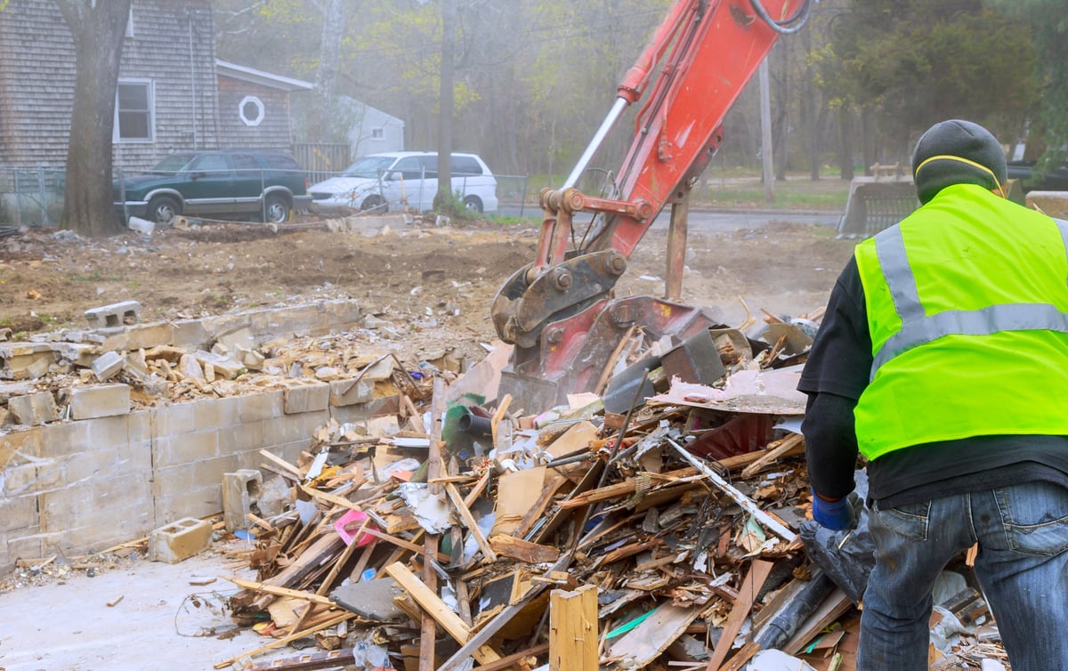 Professional construction worker clearing debris